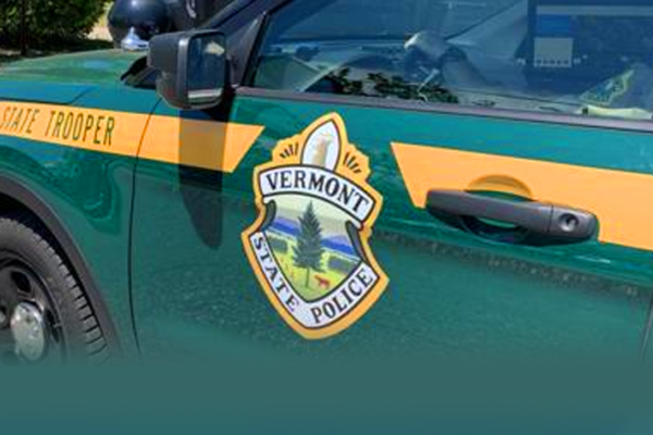 Vermont State Police vehicle and badge — South Burlington assault charges case